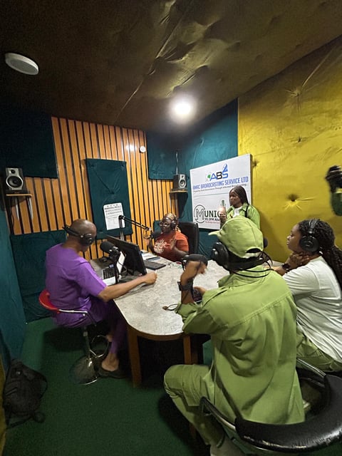 Group of people recording a podcast in a colorful studio with yellow and teal walls