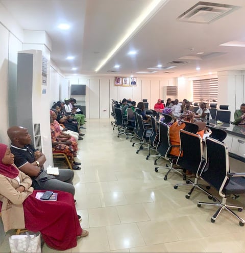 People sitting at computer workstations in a modern office or training facility
