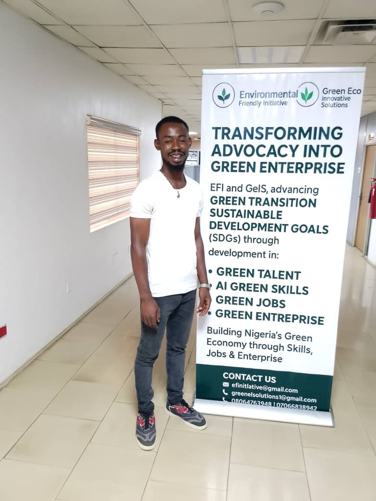 Young man standing next to a banner about environmental and green economy initiatives in Nigeria